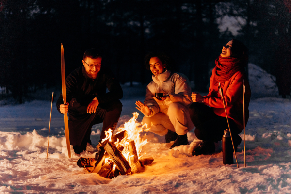 Three People having a Camp Fire